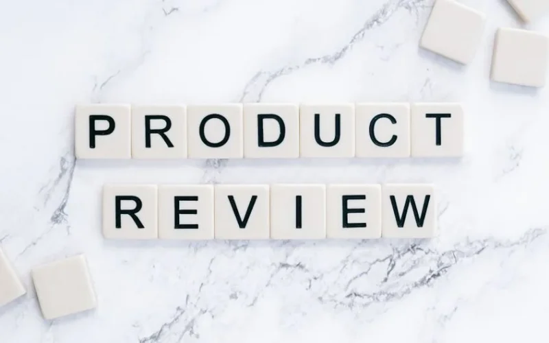 Scrabble tiles spelling 'Product Review' on a marble surface for conceptual illustration.