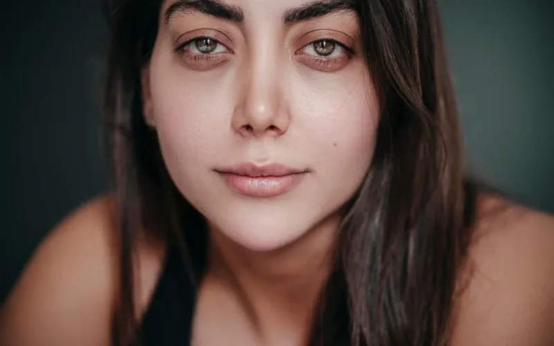 A detailed close-up portrait of a woman with captivating eyes and serene expression.