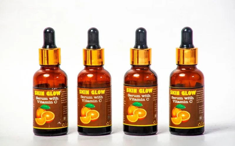 Four Vitamin C serum bottles arranged on a white background for skincare.