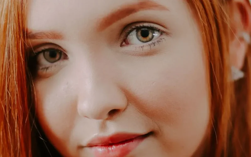 Intimate close-up of a redheaded woman showcasing natural beauty and elegance.